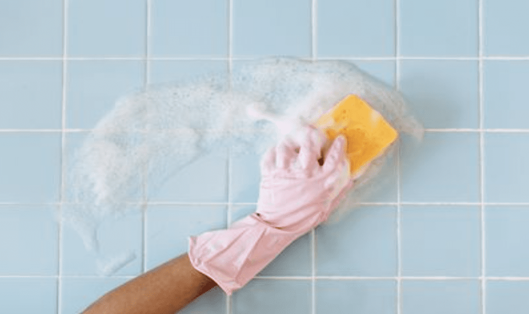 Cleaning tile wall with sponge